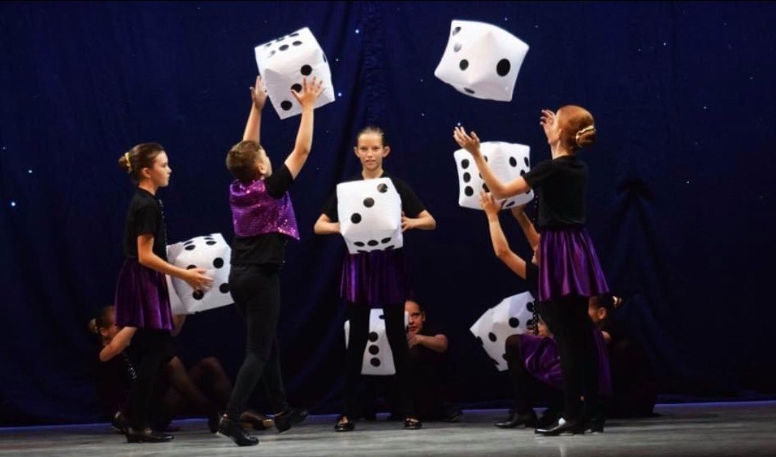 a group of students throwing large dice