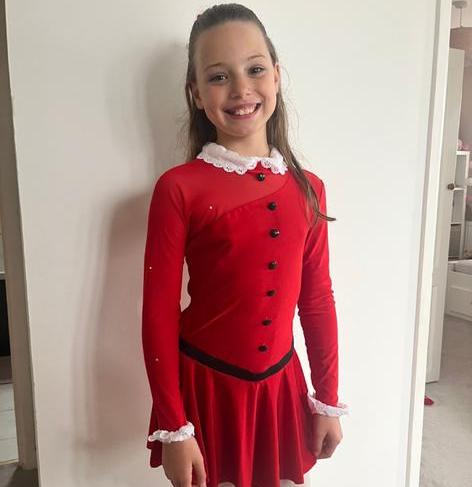 girl posing in red dance dress